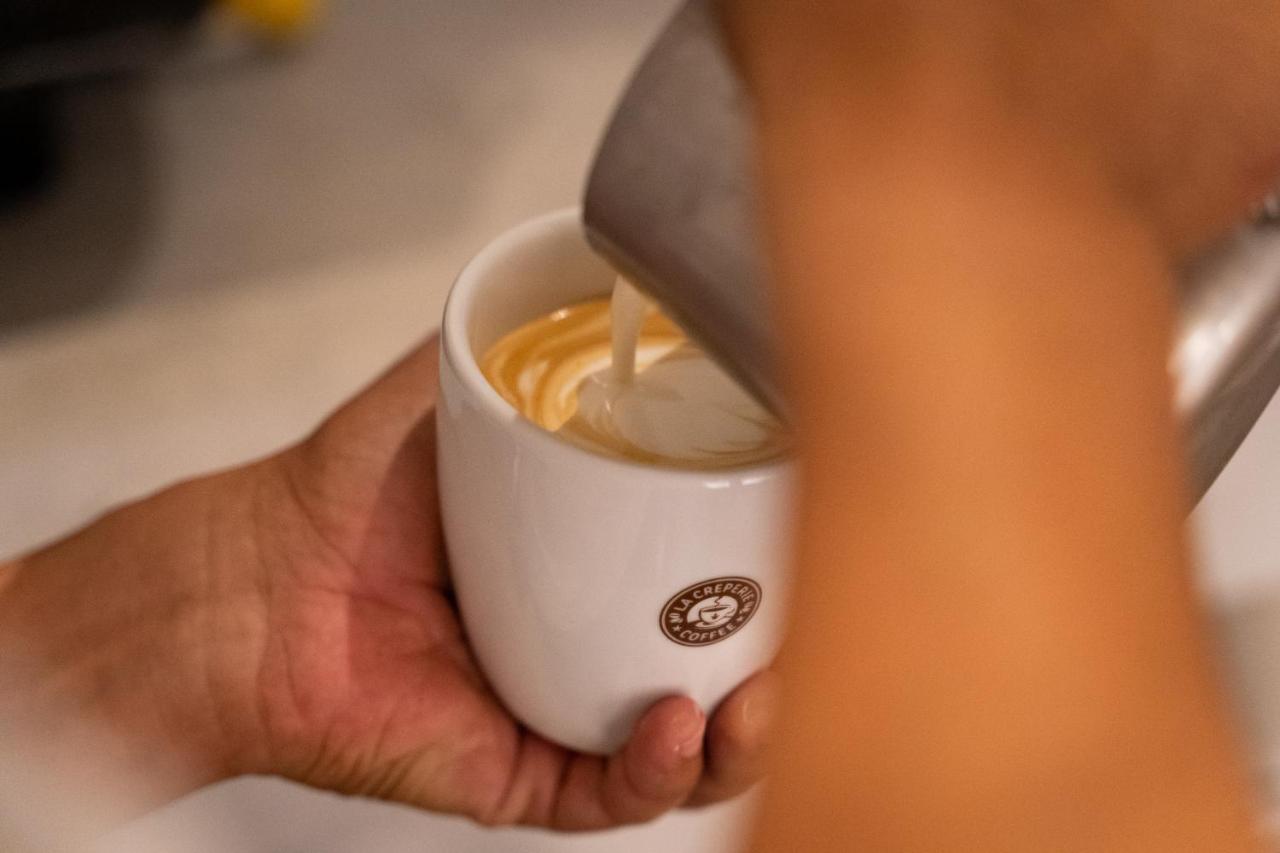 Tropical Deluxe Princess Punta Cana Exterior foto A barista prepares a cup of coffee